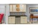 Basement wet bar with stone backsplash, cabinets and under counter refrigerator at 16815 E Prairie Goat Ave, Parker, CO 80134