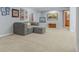 Carpeted basement featuring a comfortable gray sectional couch and wall decor at 16815 E Prairie Goat Ave, Parker, CO 80134