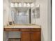 Bathroom vanity with a granite countertop, undermount sink, mirror, and paneled cabinet doors and drawers at 16815 E Prairie Goat Ave, Parker, CO 80134