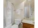 Well-lit bathroom featuring a bathtub, toilet, vanity with granite top, and a decorative shower curtain at 16815 E Prairie Goat Ave, Parker, CO 80134