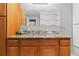 Bathroom with a vanity with a granite countertop, storage space, and decorative mirror at 16815 E Prairie Goat Ave, Parker, CO 80134