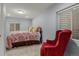Bedroom with a floral bedspread, bright, natural light, and an accent chair at 16815 E Prairie Goat Ave, Parker, CO 80134