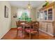 Warm dining room with a wooden table, decorative cabinet, hardwood floors, and a cozy atmosphere at 16815 E Prairie Goat Ave, Parker, CO 80134