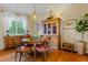 Elegant dining room with a wooden table, unique light fixture, hardwood floors, and classic decor at 16815 E Prairie Goat Ave, Parker, CO 80134