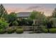 Well-maintained home exterior featuring mature landscaping, a wooden fence, and a charming curb appeal at 16815 E Prairie Goat Ave, Parker, CO 80134