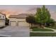 A home with a three car garage and meticulously kept front lawn with beautiful trees for curb appeal at 16815 E Prairie Goat Ave, Parker, CO 80134