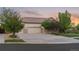 Three car garage with attractive stone accents, lush trees, and inviting curb appeal at 16815 E Prairie Goat Ave, Parker, CO 80134