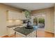Bright kitchen featuring ample counter space, modern cabinets, and a sliding glass door leading to the backyard at 16815 E Prairie Goat Ave, Parker, CO 80134