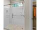 Modern walk-in shower with glass enclosure, tile surround and pebble floor at 16815 E Prairie Goat Ave, Parker, CO 80134