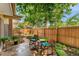 Inviting back patio with stone pavers, outdoor seating, and lush greenery for relaxation at 7427 W Cedar Cir, Lakewood, CO 80226
