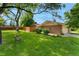 Spacious front yard featuring a well-manicured lawn, mature trees and beautiful landscaping at 7427 W Cedar Cir, Lakewood, CO 80226