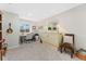 Dedicated home office space with carpeted floors, lots of natural light, and room for a sleeper sofa at 7427 W Cedar Cir, Lakewood, CO 80226