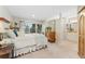 Comfortable main bedroom with a large window and access to an ensuite bathroom at 7427 W Cedar Cir, Lakewood, CO 80226