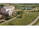 Backyard aerial view with fenced yard, trees, and nearby pond and walking path at 3741 Harvard Pl, Broomfield, CO 80023