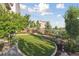 Landscaped backyard featuring a well-manicured lawn and stone retaining walls at 3741 Harvard Pl, Broomfield, CO 80023