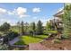 Expansive backyard view featuring lush landscaping, mature trees, and a well-maintained lawn at 3741 Harvard Pl, Broomfield, CO 80023