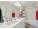 Clean bathroom with double sinks, a tub-shower, and modern lighting fixtures at 3741 Harvard Pl, Broomfield, CO 80023