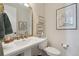 Elegant powder room featuring classic fixtures, decorative mirror, and ample natural light at 3741 Harvard Pl, Broomfield, CO 80023