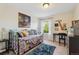 Bright bedroom features a colorful day bed, a train painting, and lots of natural light at 3741 Harvard Pl, Broomfield, CO 80023