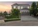 A classic two-story home with a three-car garage, nestled in a serene neighborhood at sunset at 3741 Harvard Pl, Broomfield, CO 80023