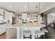This kitchen features a large island with seating, stainless appliances, and access to the second floor at 3741 Harvard Pl, Broomfield, CO 80023