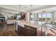 Open kitchen featuring island sink, stainless appliances, and views into living and dining spaces at 3741 Harvard Pl, Broomfield, CO 80023