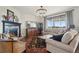 Cozy living room with stone fireplace, large window, and comfortable seating, ideal for Gathering gatherings at 3741 Harvard Pl, Broomfield, CO 80023