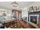 Spacious living room with elegant fireplace, comfortable seating, and open layout to the adjacent kitchen at 3741 Harvard Pl, Broomfield, CO 80023