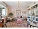 Bright living room with cozy seating, elegant chandelier, and a charming bookcase, perfect for relaxation at 3741 Harvard Pl, Broomfield, CO 80023