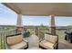 Comfortable patio seating area with wood floors and stone pillars overlooking a landscaped community at 3741 Harvard Pl, Broomfield, CO 80023