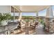 This expansive outdoor porch area offers comfortable seating, a stone fireplace, and breathtaking views at 3741 Harvard Pl, Broomfield, CO 80023