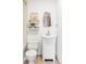 Bathroom with modern toilet, vanity, decor shelves, and bright natural light at 6580 Independence Way, Arvada, CO 80004