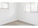 Well-lit bedroom featuring natural light from two windows and neutral carpeting and walls at 6580 Independence Way, Arvada, CO 80004