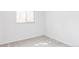 Empty bedroom featuring neutral carpeting, white walls, and warm natural light from bright window at 6580 Independence Way, Arvada, CO 80004