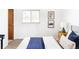 Bright bedroom featuring a cozy bed with decorative pillows and natural light from the window at 6580 Independence Way, Arvada, CO 80004