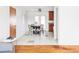 Bright dining room featuring modern decor with hardwood floors and view of the kitchen at 6580 Independence Way, Arvada, CO 80004