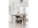 Cozy dining room with bright light, featuring modern furniture and decor with tile floors at 6580 Independence Way, Arvada, CO 80004
