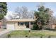Charming, ranch style home featuring a brick facade, attached garage, and a well-maintained front yard and landscaping at 6580 Independence Way, Arvada, CO 80004