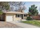 Charming, ranch style home featuring a brick facade, attached garage, and a well-maintained front yard and landscaping at 6580 Independence Way, Arvada, CO 80004