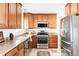 Well-equipped kitchen with wood cabinetry, granite countertops and stainless steel appliances at 6580 Independence Way, Arvada, CO 80004