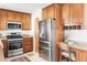 Well-equipped kitchen with wood cabinetry, granite countertops and stainless steel appliances with work station at 6580 Independence Way, Arvada, CO 80004