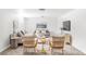 Bright living room featuring neutral decor, comfortable couches and cozy wooden lounge chairs at 6580 Independence Way, Arvada, CO 80004