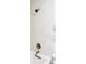 Modern shower features white tiled walls and a sleek bronze shower head and fixtures at 6580 Independence Way, Arvada, CO 80004