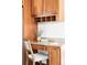 Bright work station featuring wood cabinetry, granite countertops, and decor at 6580 Independence Way, Arvada, CO 80004
