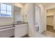 Bathroom featuring a vanity area with sink and walk in closet at 39857 Floyd St, Elizabeth, CO 80107