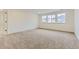 Cozy bedroom with plush carpet and natural light from three windows at 39857 Floyd St, Elizabeth, CO 80107