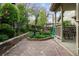 Well-maintained backyard featuring a stone paver patio, tiered garden beds and green landscaping at 17038 Lamar Dr, Parker, CO 80134