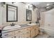 Spacious bathroom with double sink vanity, decorative mirrors, tiled walls and tub and shower combo at 17038 Lamar Dr, Parker, CO 80134