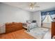 Bedroom featuring a white framed twin bed, blue accents, ceiling fan and wood laminate floors at 17038 Lamar Dr, Parker, CO 80134
