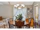 Warm dining area features a wood table, chandelier, and built in cabinet at 17038 Lamar Dr, Parker, CO 80134
